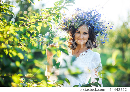 beautiful young woman with flower wreath in the beautiful young woman with flower wreath in the 34442832