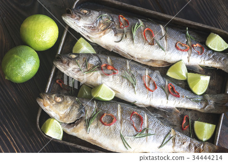 Baked sea bass with lime and chilli pepper Baked sea bass with lime and chilli pepper 34444214