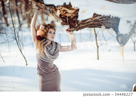 beautiful girl in the winter forest  34446227
