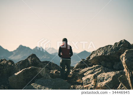 Hiker in high altitude rocky mountain landscape Hiker in high altitude rocky mountain landscape 34446945
