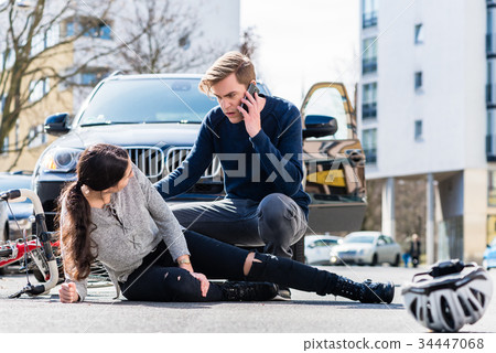 Worried young driver calling the ambulance after 34447068