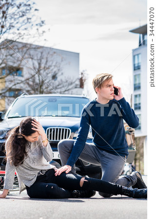 Worried young driver calling the ambulance after 34447070