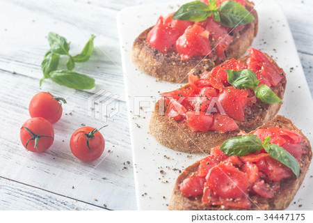 Bruschetta with cherry tomatoes and basil Bruschetta with cherry tomatoes and basil 34447175
