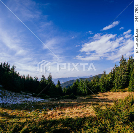 Sunlit mountain slope 34447908