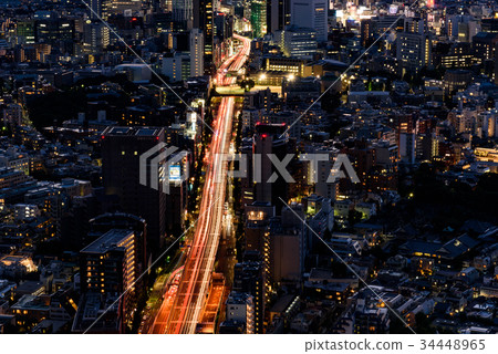 Urban scenery of central Tokyo and traces of light of cars running on a boulevard Urban scenery of central Tokyo and traces of light of cars running on a boulevard 34448965