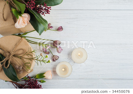 Gifts and lit candles, flower Gifts and lit candles, flower 34450076