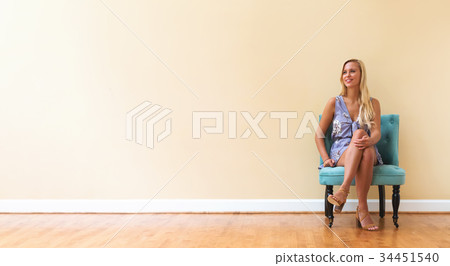 Young woman sitting in a big room Young woman sitting in a big room 34451540