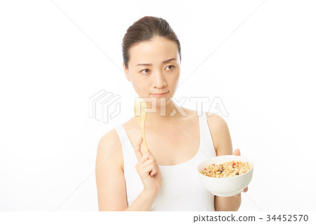 A woman eating cereal 34452570
