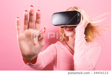 Young woman using virtual reality headset Young woman using virtual reality headset 34454113