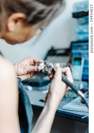 The girl is engaged in jewelry business The girl is engaged in jewelry business 34454657