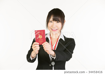 Correspondence to overseas business trips is a business person's essential skill. Business woman holding a passport Correspondence to overseas business trips is a business person's essential skill. Business woman holding a passport 34458416