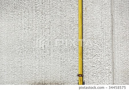 Old water metal pipes fixed with brackets in front 34458575