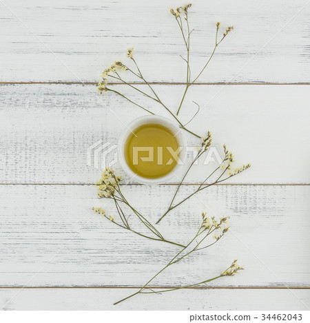 Yellow limonium caspia flowers with a cup of tea Yellow limonium caspia flowers with a cup of tea 34462043