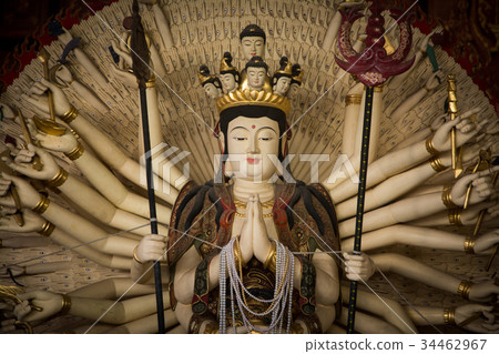 The statue of the monk looks calm. 34462967