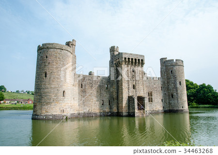 An old castle surrounded by a pond outside England An old castle surrounded by a pond outside England 34463268