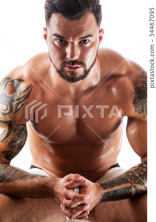 Young man with tattooed torso posing in underwear 34467095