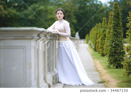 Woman in white Victorian dress in spring park 34467150