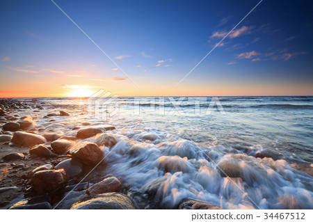 Sunset over the Baltic sea. The pebbly beach Sunset over the Baltic sea. The pebbly beach 34467512