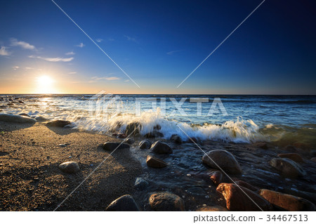 Sunset over the Baltic sea. The pebbly beach Sunset over the Baltic sea. The pebbly beach 34467513