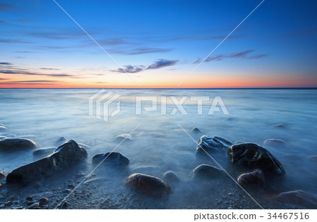 Sunset over the Baltic sea. The pebbly beach Sunset over the Baltic sea. The pebbly beach 34467516
