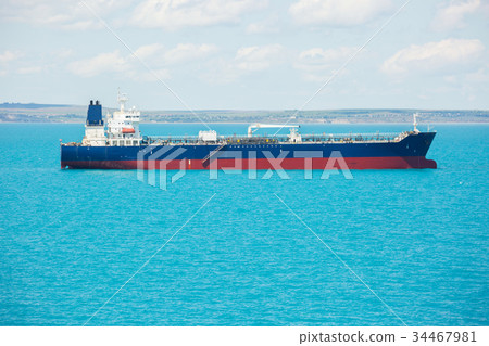 Small oil product tanker at anchor. 34467981