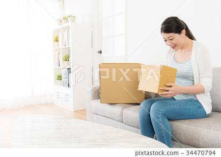 young beautiful lady received delivery package 34470794