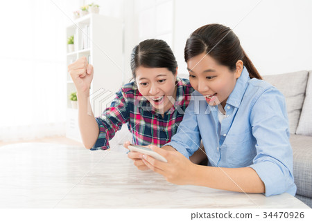 girl using mobile smartphone playing game girl using mobile smartphone playing game 34470926