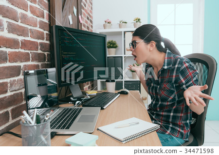 beautiful programmer woman looking at computer 34471598