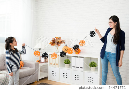 cute girl holding decorations with her mother cute girl holding decorations with her mother 34471751