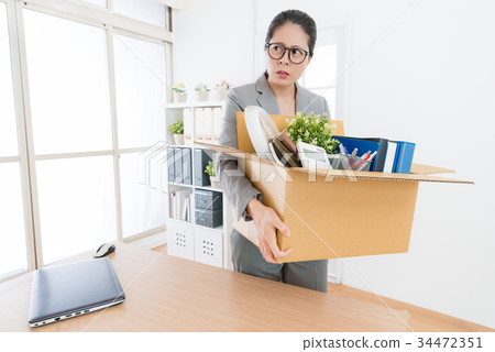office worker woman holding personal items box 34472351