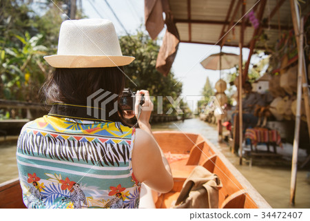 traveler using camera taking picture of vendors traveler using camera taking picture of vendors 34472407