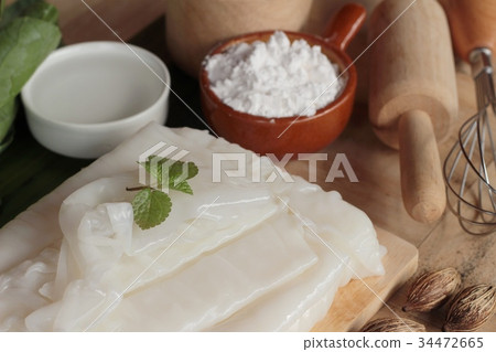 Making rice noodle flat on wood background. 34472665