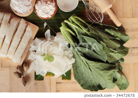 Making rice noodle flat on wood background. Making rice noodle flat on wood background. 34472678