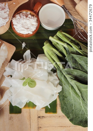 Making rice noodle flat on wood background. Making rice noodle flat on wood background. 34472679