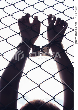 hand holding fence 34473069