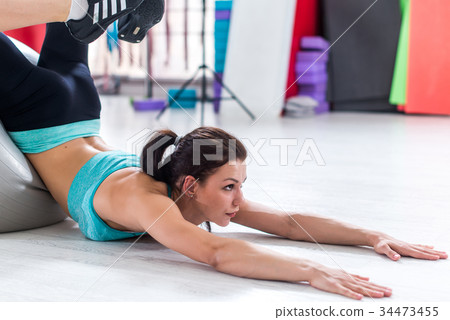 Young brunette stretching her back trying to reach 34473455