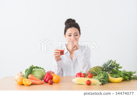 A woman drinking tomato juice 34474077