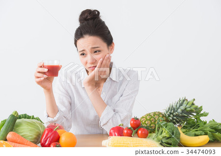 A woman drinking tomato juice A woman drinking tomato juice 34474093