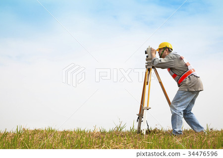 Surveyor engineer making measure on the field 34476596