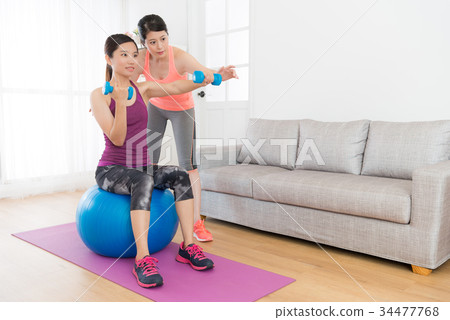 home fitness tutor woman teaching her student home fitness tutor woman teaching her student 34477768