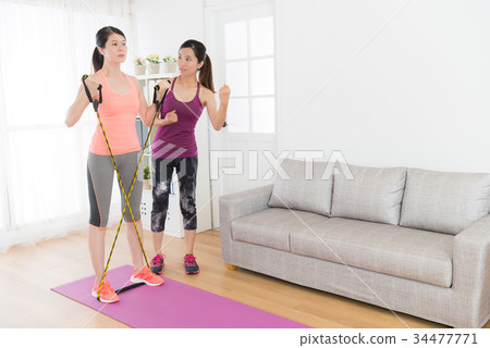 young pretty woman pulling resistance band 34477771