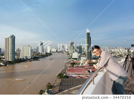 Asian man with Chao Phraya River at noon in Bangkok, Thailand 34478358