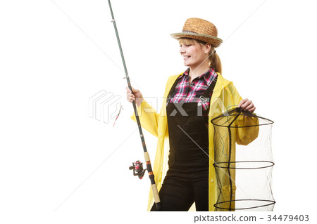 Happy woman holding fishing rod and keepnet Happy woman holding fishing rod and keepnet 34479403
