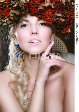 Beautiful girl with rowan wreath on her head 34479471