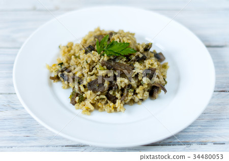 Italian dish Risotto. Garnish dish with mushrooms. Italian dish Risotto. Garnish dish with mushrooms. 34480053