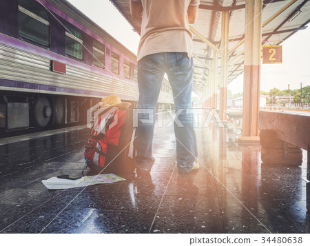 Traveler with backpack in train station Traveler with backpack in train station 34480638