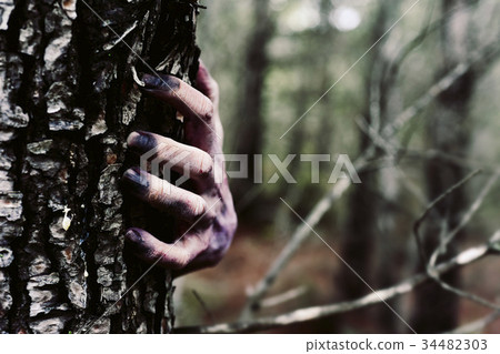 zombie or monster hiding behind a tree 34482303