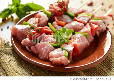 raw turkey meat and vegetables skewers 34482305