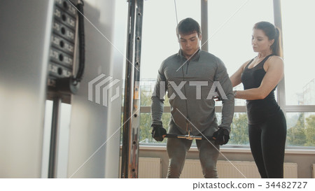 Athlete man performs exercises in the gym 34482727