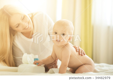 Portrait of happy mother with infant son Portrait of happy mother with infant son 34482979